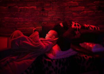 Svyatoslav, 6, plays with his tablet in a public basement used as a bomb shelter. Photograph: Emilio Morenatti/AP