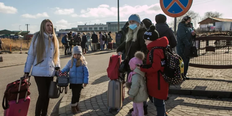 A slow but steady stream of people cross the border into Medyka, Poland from Ukraine in the hours after bombing started outside Lviv on Thursday. ANNA LIMINOWICZ /THE GLOBE AND MAIL