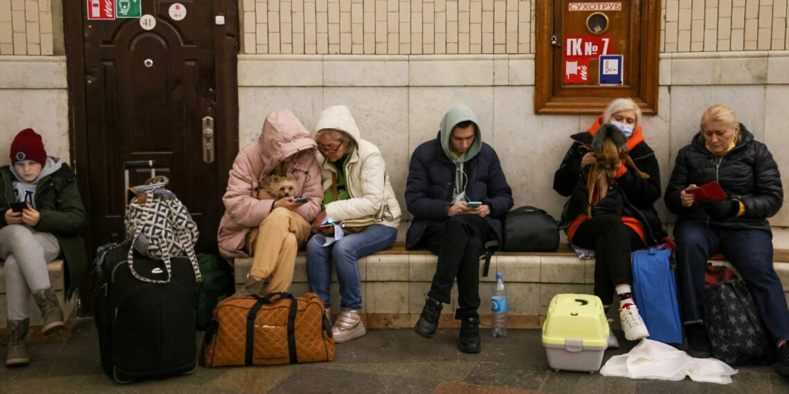 People gather at a subway station in Kyiv on February 24 as they seek shelter from expected Russian air strikes / RFL