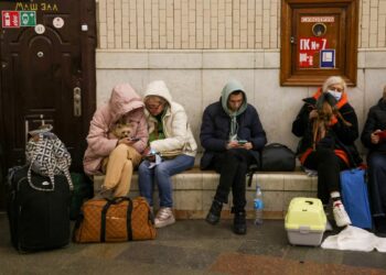People gather at a subway station in Kyiv on February 24 as they seek shelter from expected Russian air strikes / RFL