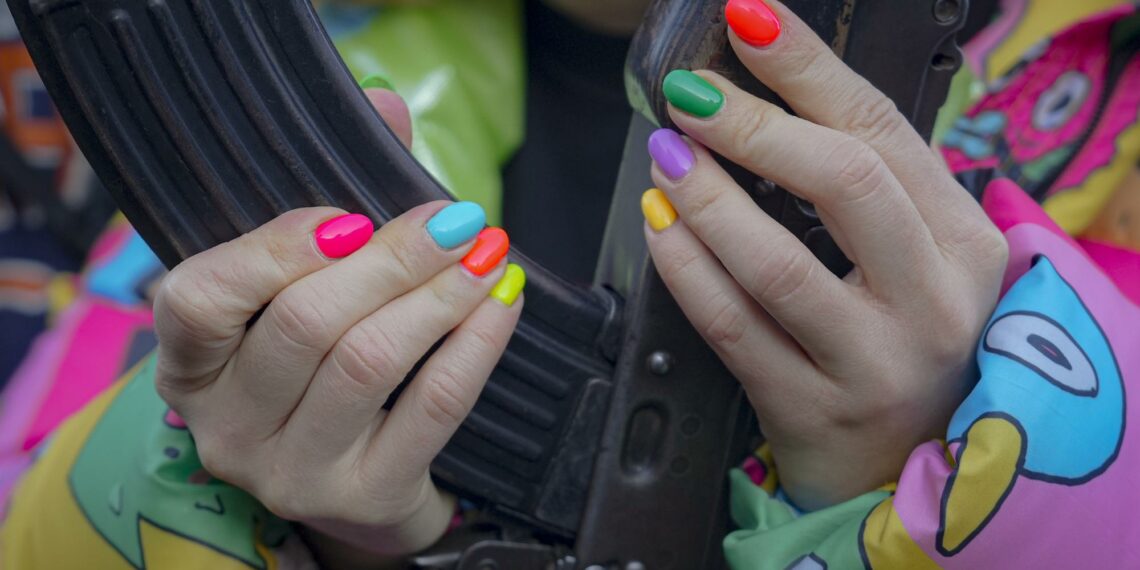 A young woman handles a weapon during a basic combat training for civilians, organized by the Special Forces Unit Azov, of Ukraine's National Guard, in Mariupol, Donetsk region, eastern Ukraine, Sunday, Feb. 13, 2022. (AP Photo/Vadim Ghirda)