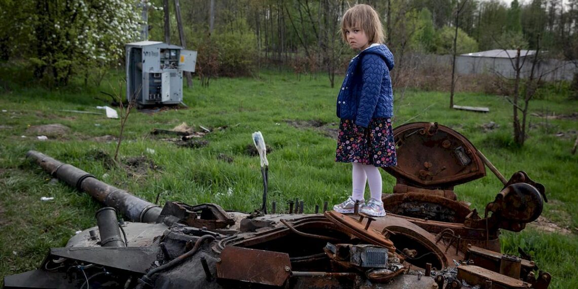 Girl stands on the tower of a destroyed Russian tank near Makariv village, Kyiv region, Ukraine, May 7, 2022. by Mikhail Palinchak.