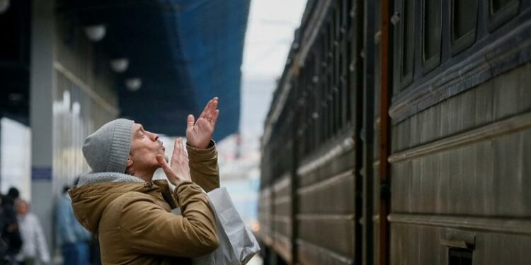 A man says goodbye to his relatives as an evacuation train from Kyiv to Lviv leaves from Kyiv central train station, March 6. REUTERS/Gleb Garanich