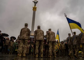 Honour guards carry the coffin of Ukrainian army paramedic Nazarii Lavrovskyi who was killed in the Kharkiv area of eastern Ukraine [Francisco Seco/AP Photo]