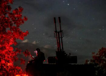 A Ukrainian serviceman from an anti-drone mobile air defence unit uses his mobile device near a ZU-23-2 anti aircraft cannon as he waits for Russian kamikaze drones, in Kherson region, Ukraine, June 11. REUTERS/Ivan Antypenko