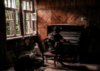 A serviceman of 24th Mechanized brigade, named after King Danylo, of the Ukrainian Armed Forces plays a piano in a damaged building in the frontline town of Chasiv Yar in Donetsk region, Ukraine, June 25. Oleg Petrasiuk/24th King Danylo Separate Mechanized Brigade