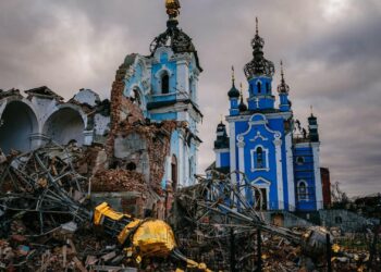 Construction workers climb onto the roof of a destroyed church on January 4, 2023, in the village of Bohorodychne, Ukraine. (Dimitar Dilkoff/AFP via Getty Images)