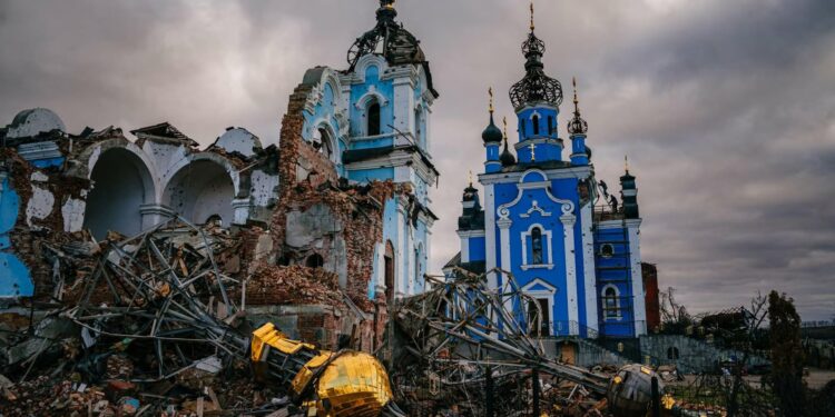 Construction workers climb onto the roof of a destroyed church on January 4, 2023, in the village of Bohorodychne, Ukraine. (Dimitar Dilkoff/AFP via Getty Images)