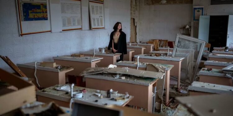 "What happened is a tragedy. I have already cried out about everything I lost. I miss my school, friends, and teachers." said student, 16, as she views her former classroom that was bombed by Russian forces. Photo by Emilio Morenatti / AP